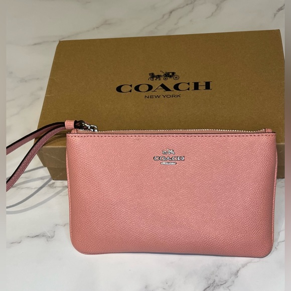Coach Handbags - NWOT Small coach wristlet purse in pink- BRAND NEW